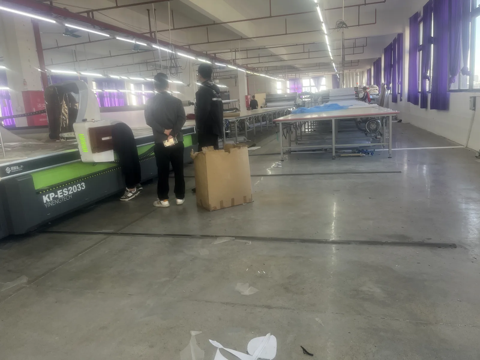 Production workshop with equipment and staff working on sportswear orders